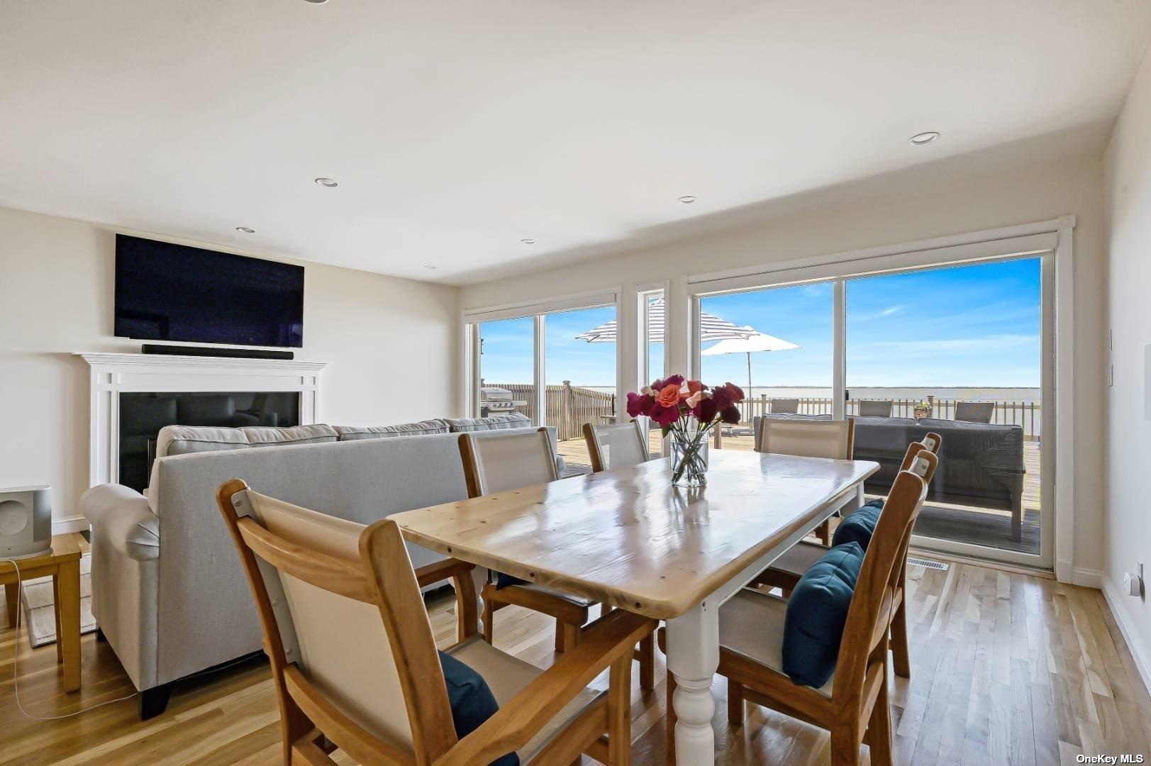23 A Oakhurst Road Hampton Bays, NY 11946 - Photo 9 of 16 a view of a dining room with furniture window and wooden floor