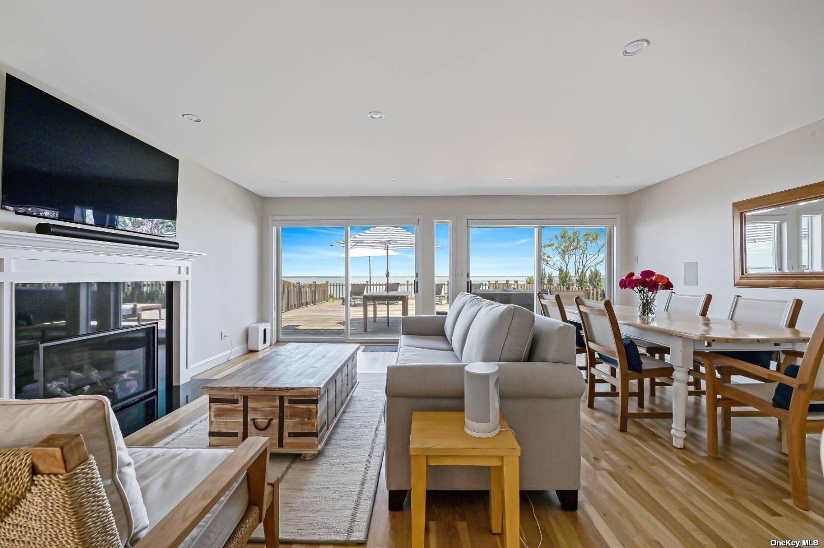 23 A Oakhurst Road Hampton Bays, NY 11946 - Photo 10 of 16 a living room with furniture flat screen tv and kitchen view