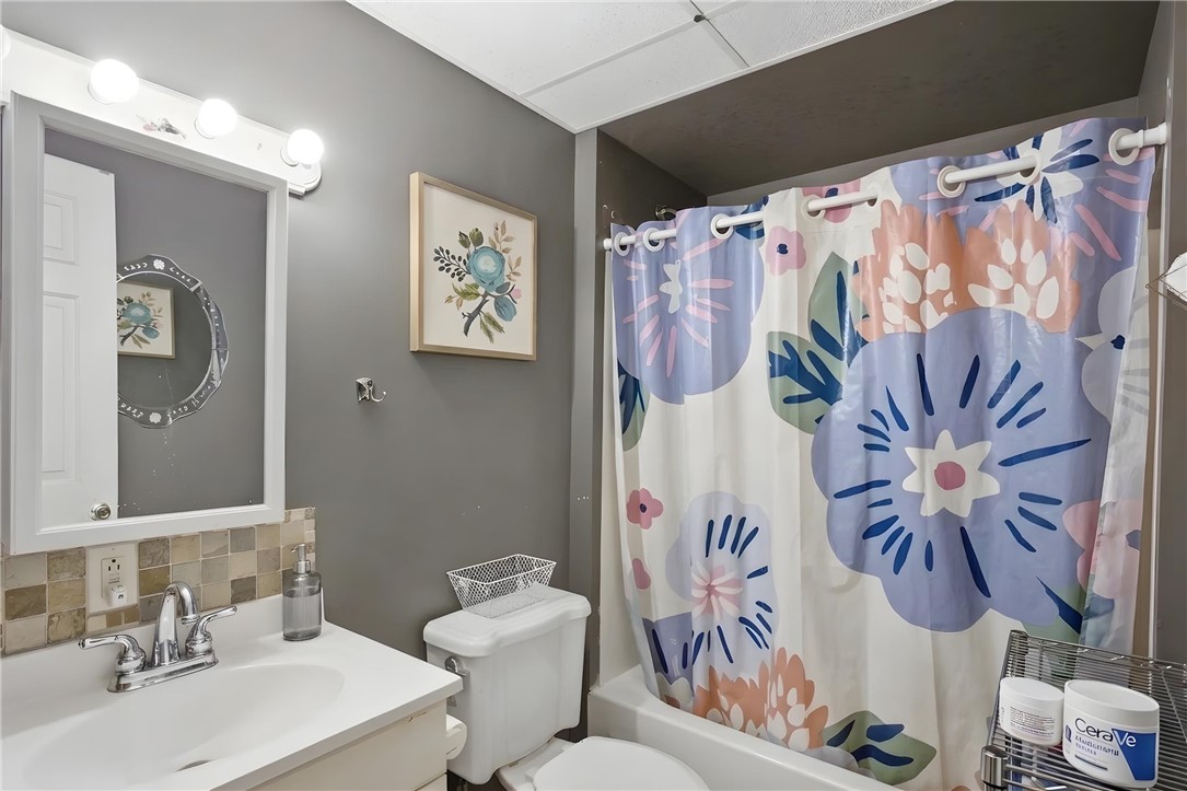 311 Cumberland Way Anderson, SC 29621 - Photo 28 of 44 A well-appointed bath with a tiled vanity and a vibrant shower curtain offers everyday comfort.