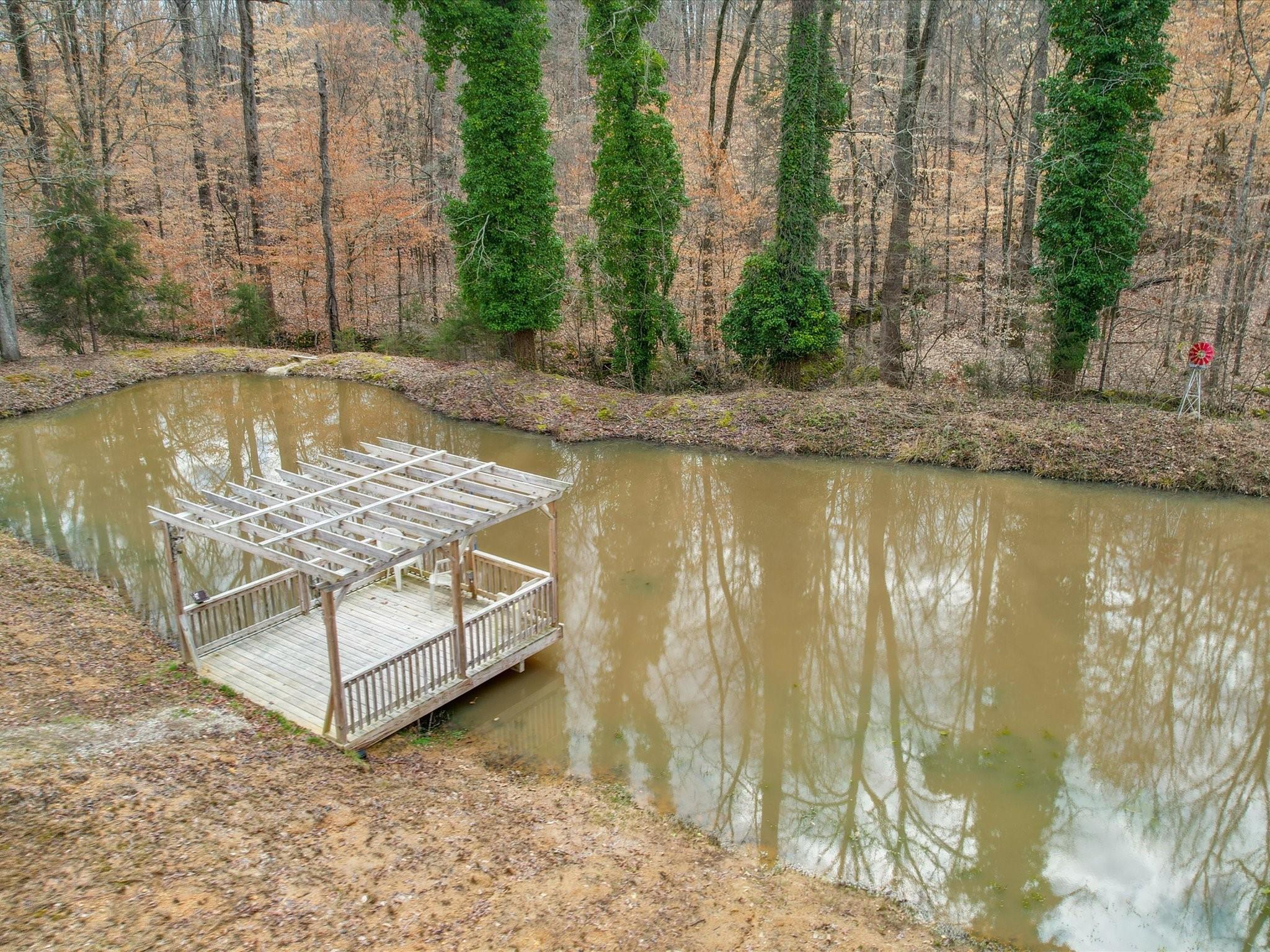 989 Pinckney Road Chester, SC 29706 - Photo 8 of 44 a view of a lake with a yard and wooden fence