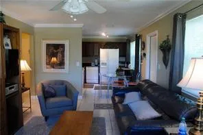 a living room with furniture a large window and a flat screen tv