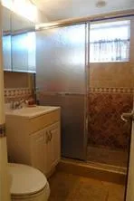 a bathroom with a toilet a sink and shower