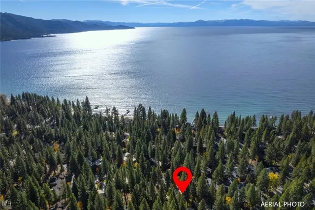 a view of a back yard of a building with a lake view
