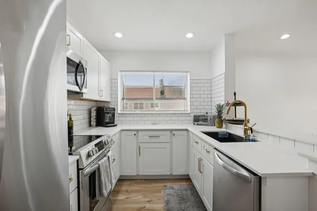 a kitchen with a sink stove and cabinets