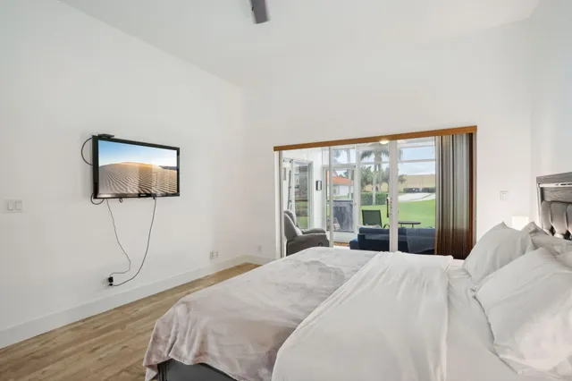 a bedroom with a bed and a flat screen tv