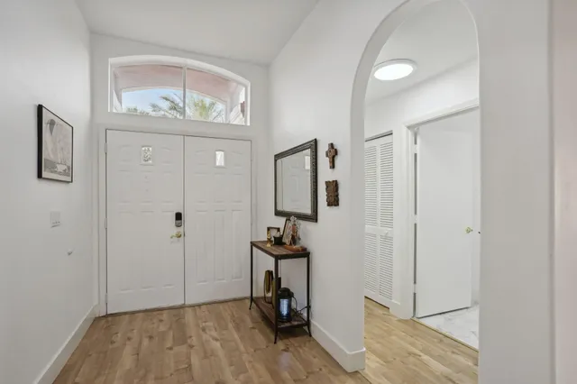 a view of a hallway with wooden floor and staircase