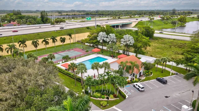 an aerial view of residential houses with outdoor space and street view