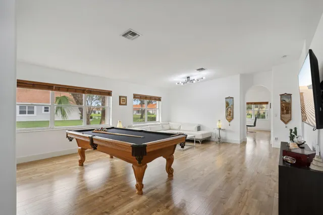 a dining room with furniture and wooden floor