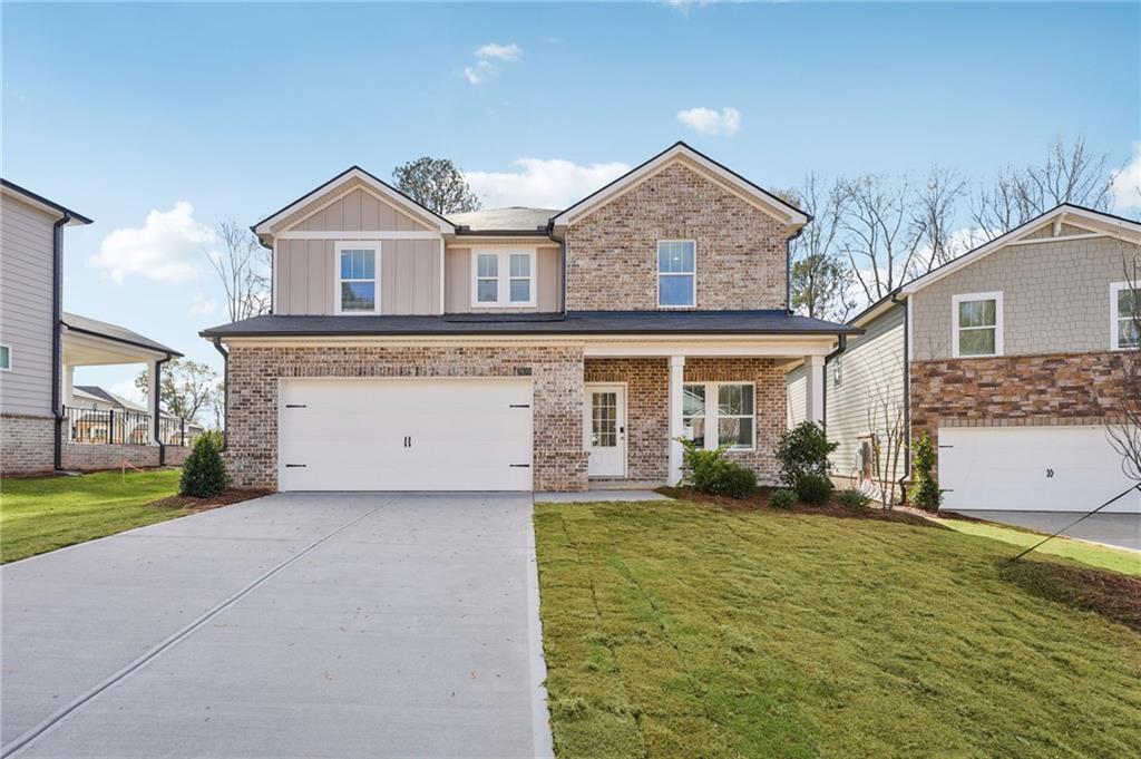 3939 Ladiga Street Powder Springs, GA 30127 - Photo 1 of 1 a view of a house with a yard and garage