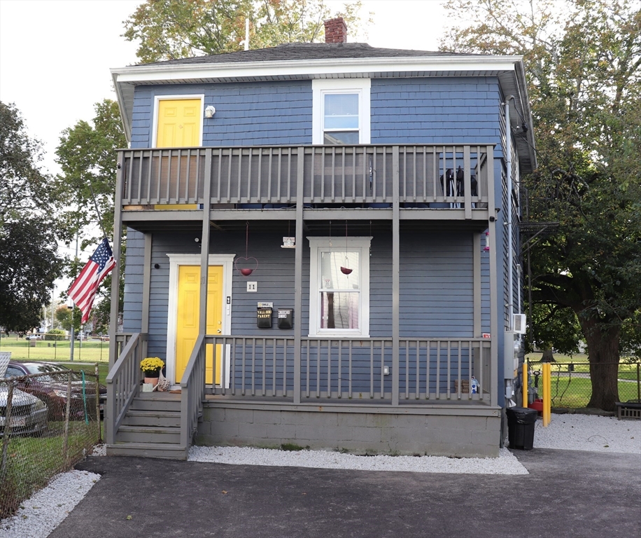 a view of a house with a window and wooden fence