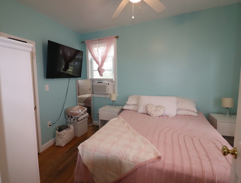 11 Palmer Street Fall River, MA 02724 - Photo 12 of 34 a bedroom with a bed and flat screen tv