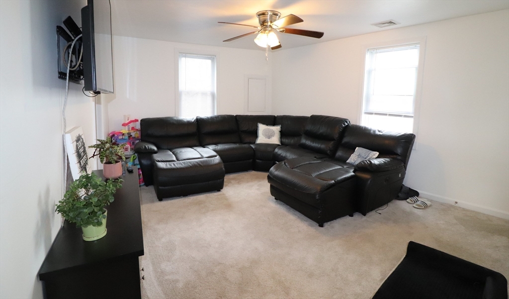 11 Palmer Street Fall River, MA 02724 - Photo 19 of 34 a living room with furniture and a flat screen tv