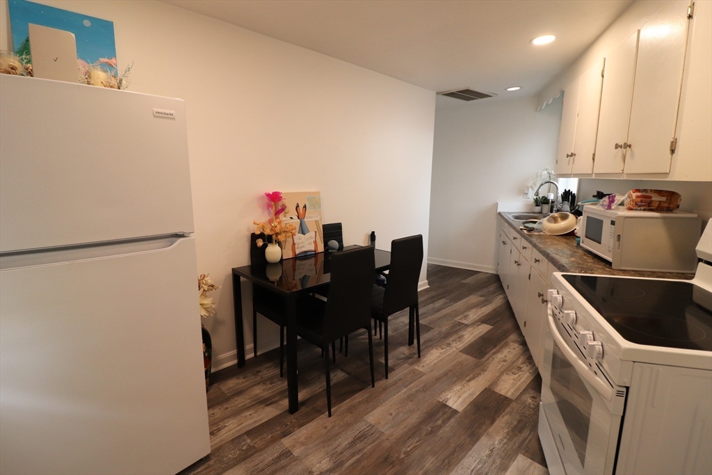 11 Palmer Street Fall River, MA 02724 - Photo 21 of 34 a kitchen with a table chairs and a refrigerator