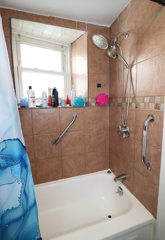 11 Palmer Street Fall River, MA 02724 - Photo 27 of 34 a bathroom with a tub sink mirror and vanity