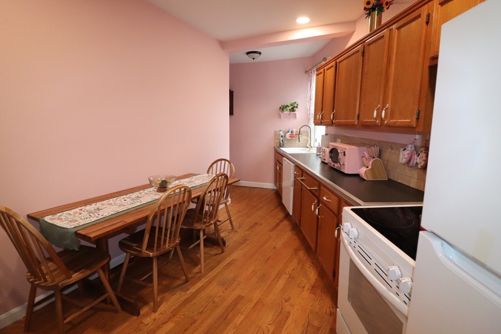 11 Palmer Street Fall River, MA 02724 - Photo 9 of 34 a kitchen with a wooden cabinets and stove
