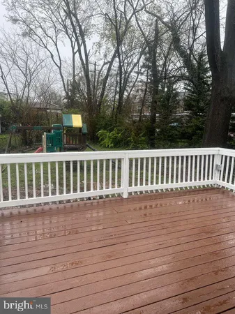 a view of wooden deck and a yard