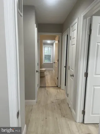 a view of a hallway with wooden shelves