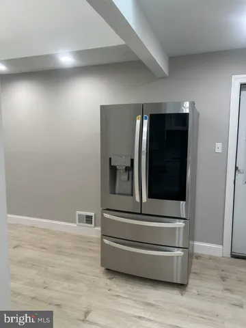 a room with wooden floor and cabinets