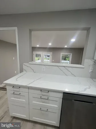 a kitchen with a white cabinets and sink