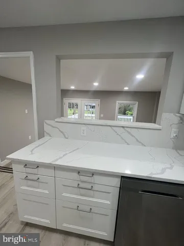 a kitchen with a white cabinets and sink