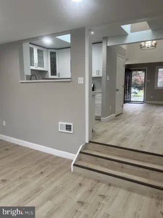 a view of a livingroom with wooden floor and a window
