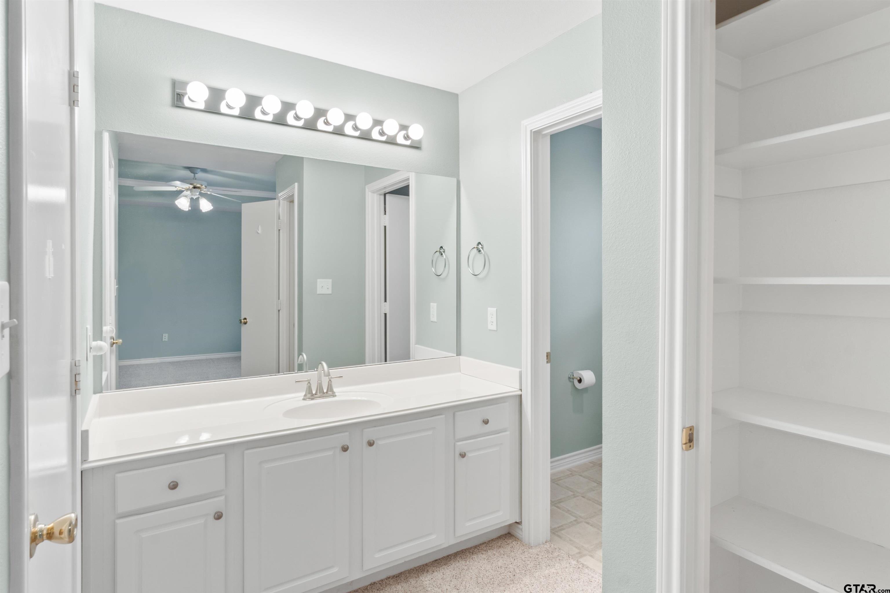 1521 Rice Road, Unit G102 Tyler, TX 75703 - Photo 14 of 23 a spacious bathroom with a shower a sink and a mirror