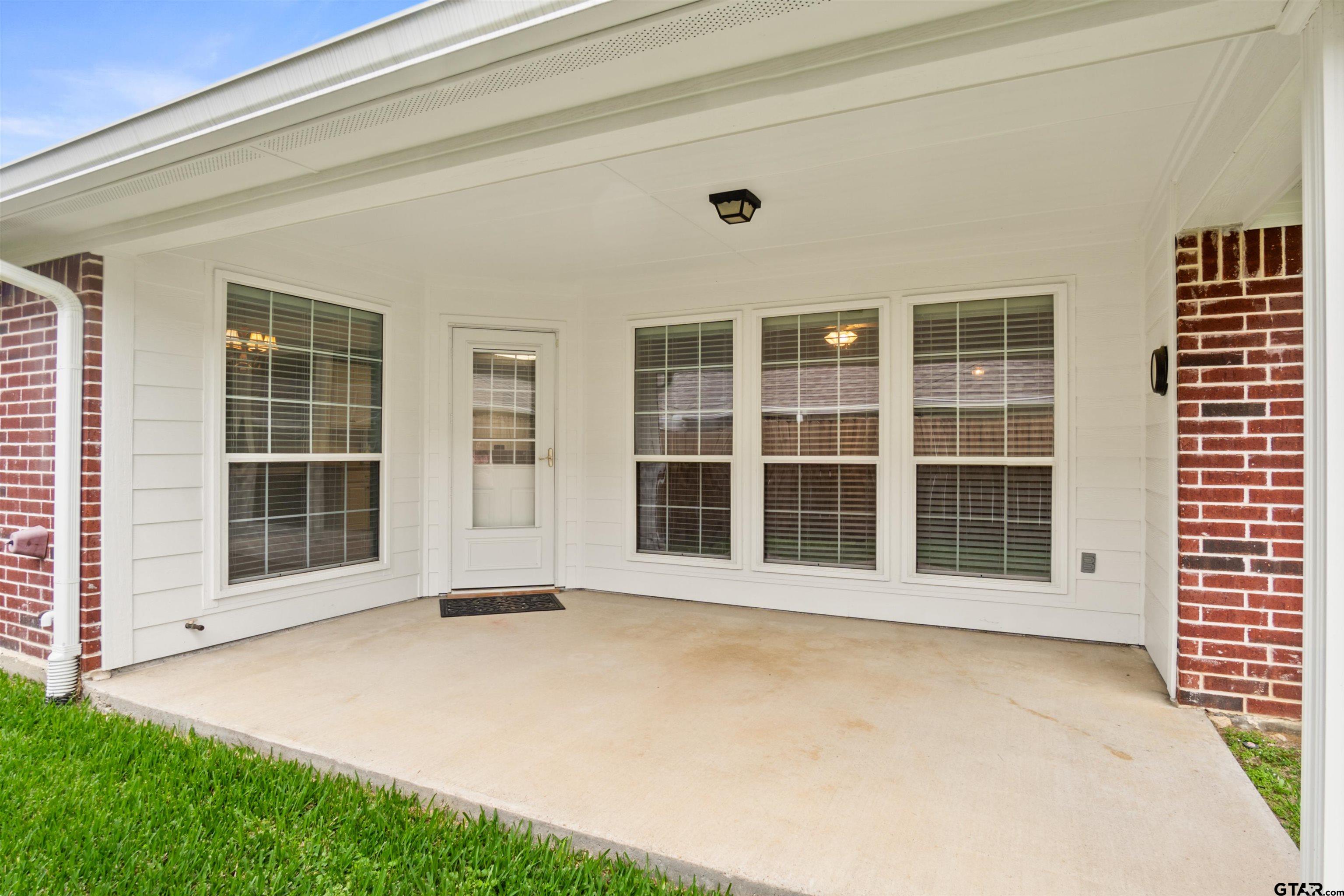 1521 Rice Road, Unit G102 Tyler, TX 75703 - Photo 22 of 23 a front view of a house with a garden