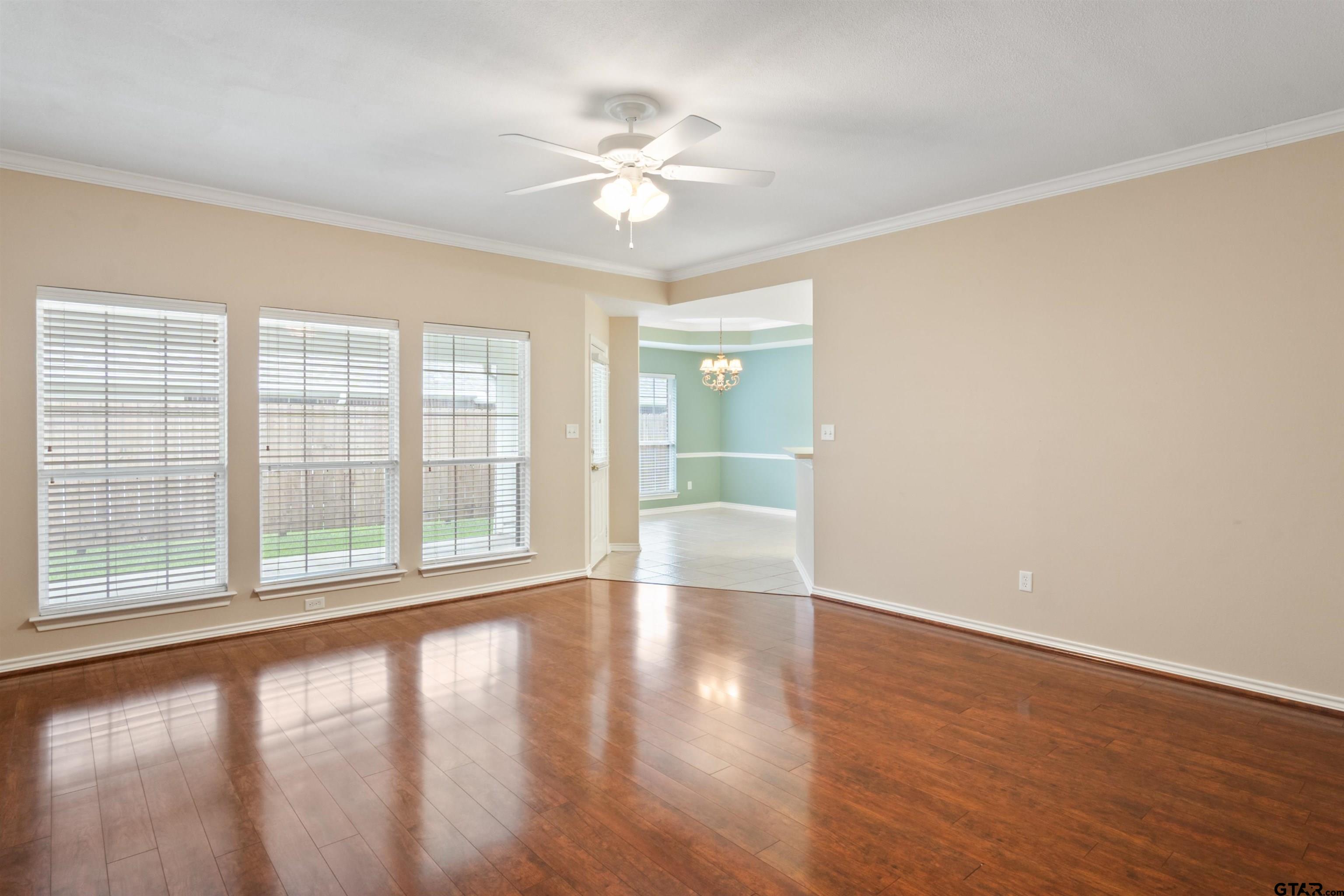 1521 Rice Road, Unit G102 Tyler, TX 75703 - Photo 3 of 23 a view of an empty room with wooden floor and a window