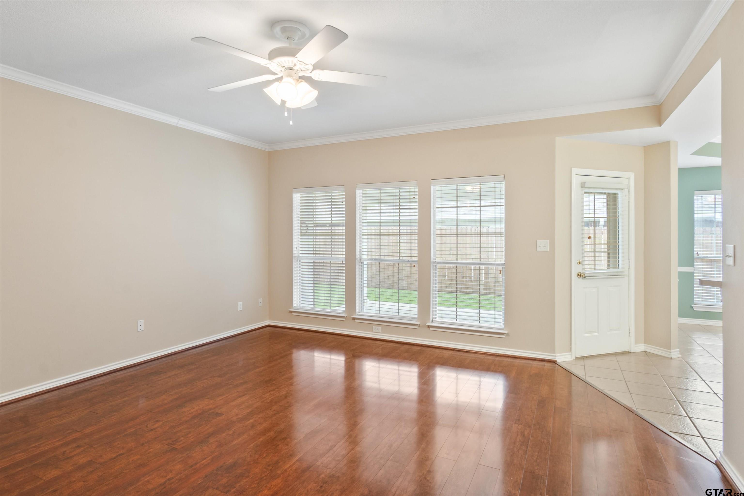 1521 Rice Road, Unit G102 Tyler, TX 75703 - Photo 4 of 23 wooden floor in an empty room with a window
