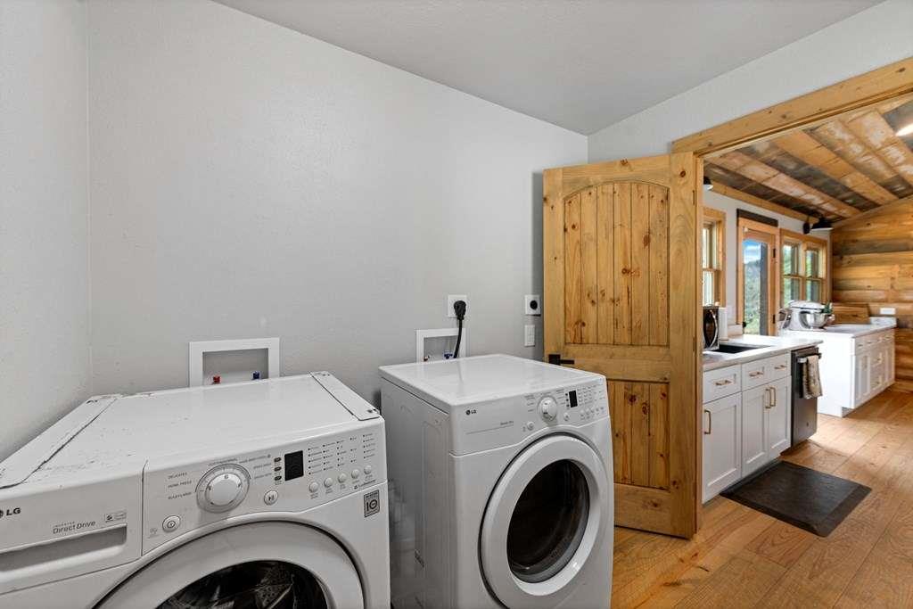 384 Maxwell Road Blue Ridge, GA 30513 - Photo 26 of 68 a view of washer and dryer with kitchen in the background