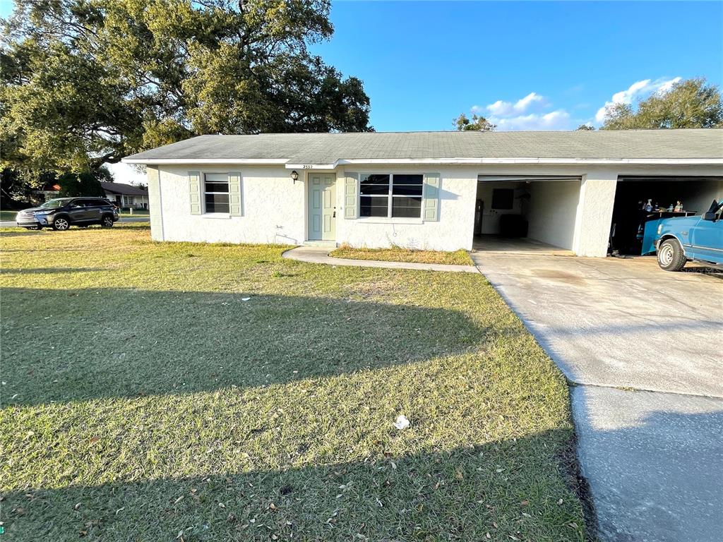 2552 6th Street St. Cloud, FL 34769 - Photo 1 of 1 a front view of a house with a yard