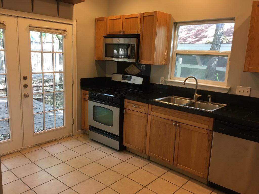 4802 Clarkson Avenue Austin, TX 78751 - Photo 13 of 38 a kitchen with a sink and a stove top oven
