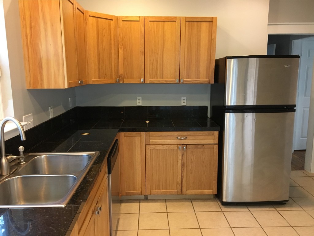 4802 Clarkson Avenue Austin, TX 78751 - Photo 18 of 38 a kitchen with a refrigerator and a sink
