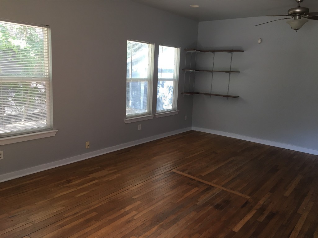 4802 Clarkson Avenue Austin, TX 78751 - Photo 19 of 38 an empty room with wooden floor and windows