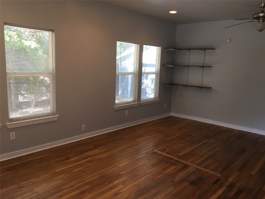 4802 Clarkson Avenue Austin, TX 78751 - Photo 20 of 38 an empty room with wooden floor and windows