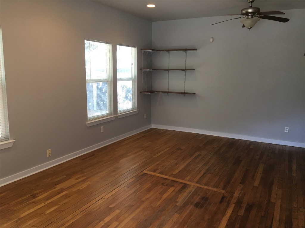 4802 Clarkson Avenue Austin, TX 78751 - Photo 21 of 38 wooden floor in an empty room with a window