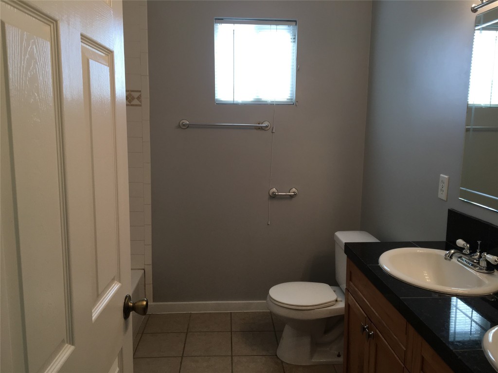 4802 Clarkson Avenue Austin, TX 78751 - Photo 35 of 38 a bathroom with a sink toilet and a mirror