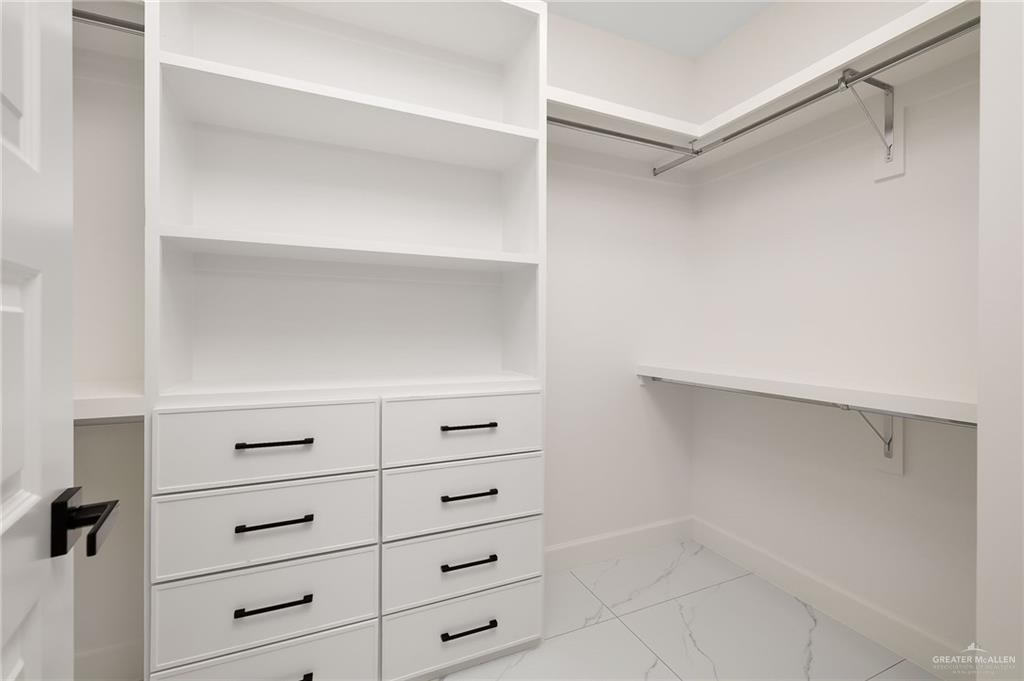 901 Azalea Street Mission, TX 78573 - Photo 17 of 29 Walk in closet featuring extra cabinetry and show rack