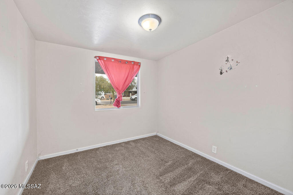 1301 West Kleindale Road Tucson, AZ 85705 - Photo 16 of 27 an empty room with a fan