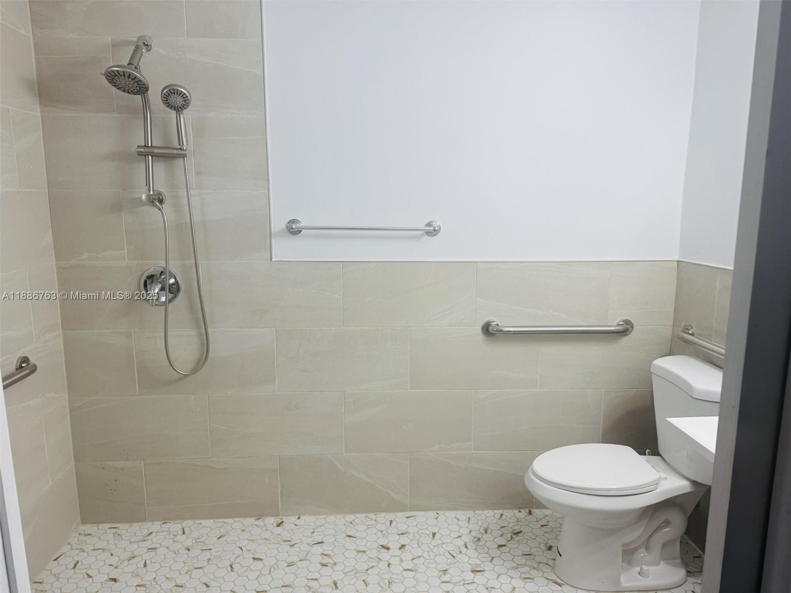 3915 Northwest 4th Terrace Miami, FL 33126 - Photo 11 of 42 a bathroom with a toilet and a shower