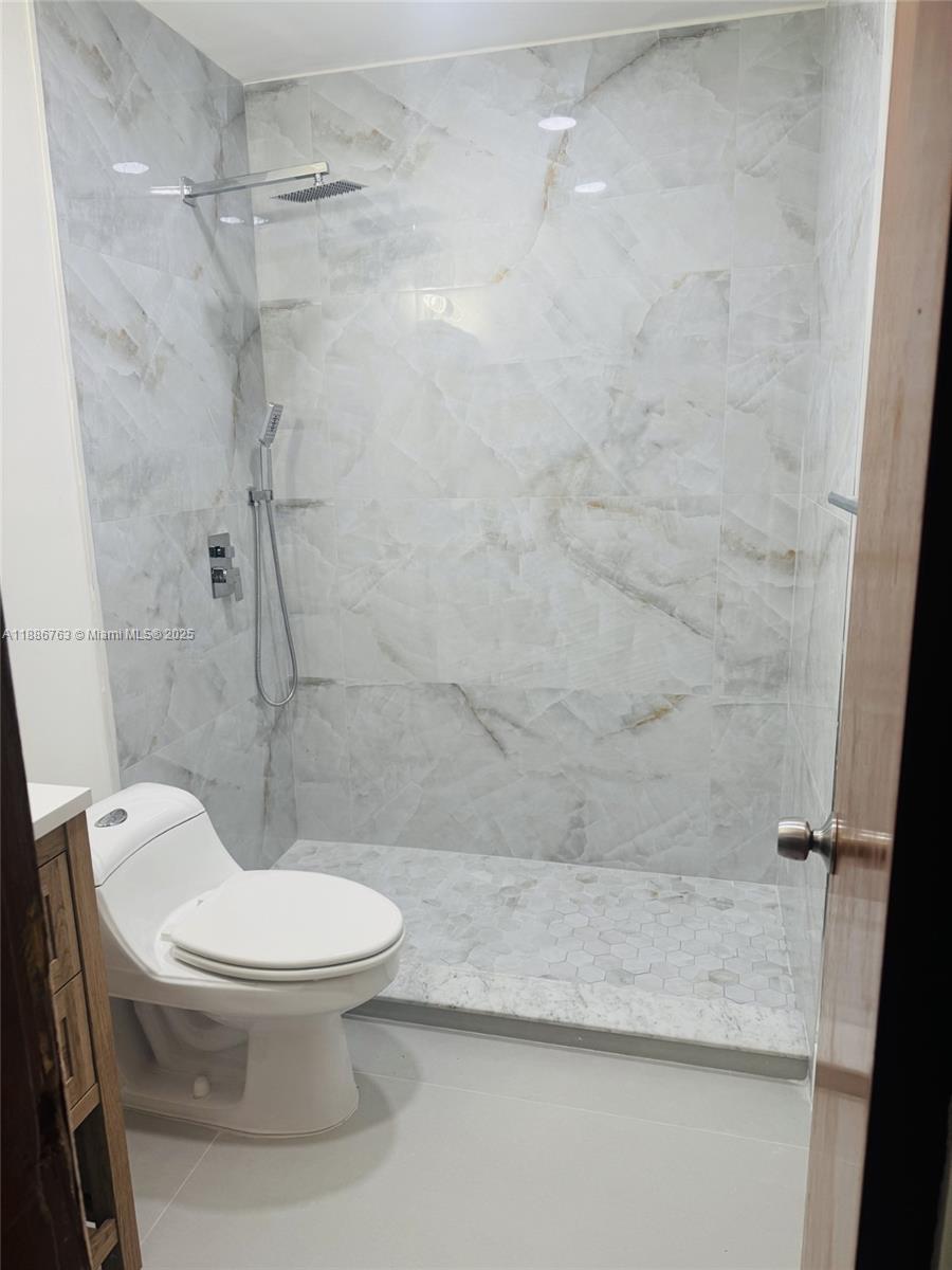 3915 Northwest 4th Terrace Miami, FL 33126 - Photo 13 of 42 a white toilet sitting next to a bath tub