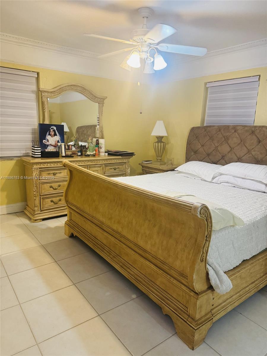 3915 Northwest 4th Terrace Miami, FL 33126 - Photo 18 of 42 a spacious bedroom with a bed and ceiling fan