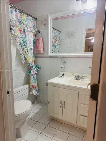 a kitchen with white cabinets a sink and appliances