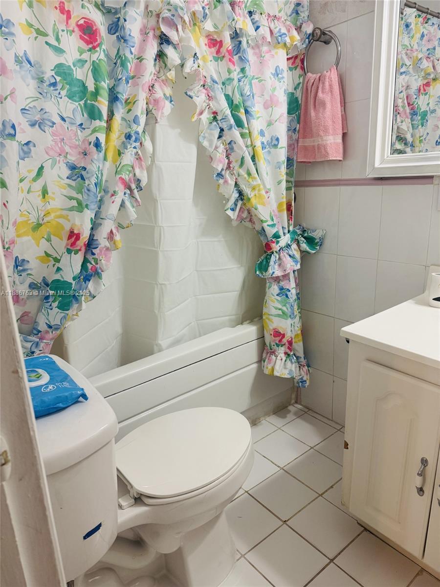 3915 Northwest 4th Terrace Miami, FL 33126 - Photo 20 of 42 a bathroom with a toilet sink and curtain