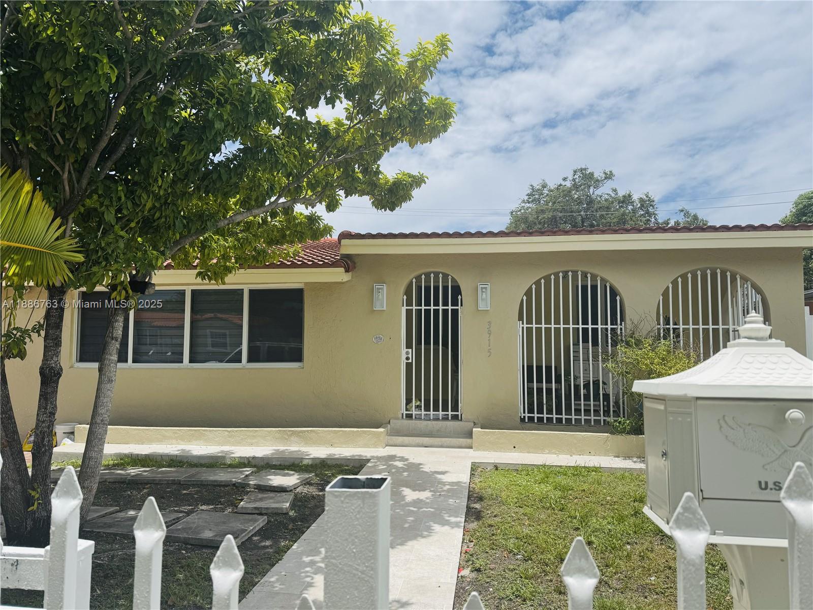 3915 Northwest 4th Terrace Miami, FL 33126 - Photo 3 of 42 a front view of a house with garden