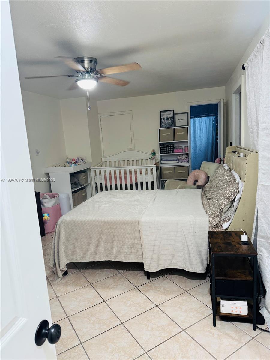 3915 Northwest 4th Terrace Miami, FL 33126 - Photo 36 of 42 a bedroom with a bed and a chair