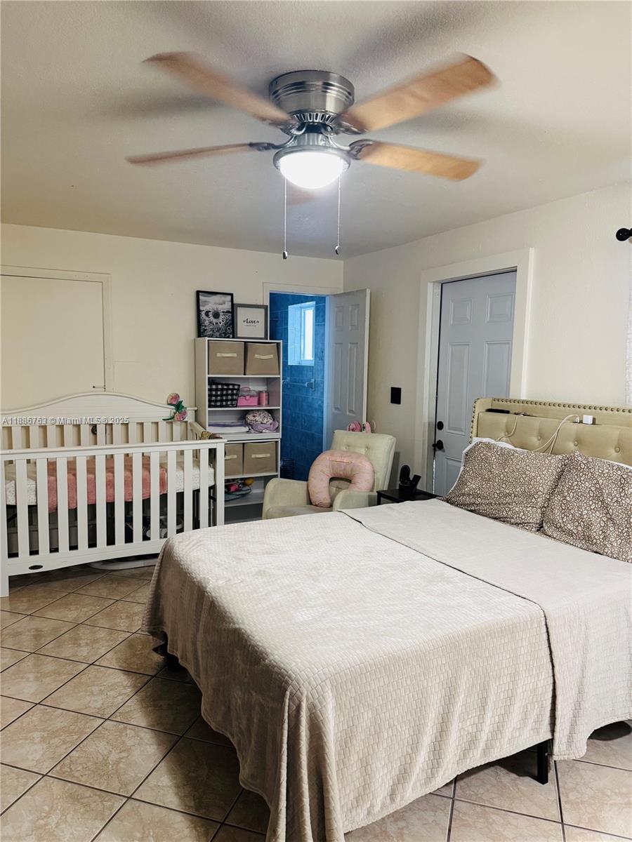 3915 Northwest 4th Terrace Miami, FL 33126 - Photo 37 of 42 a bedroom with a bed and a chandelier