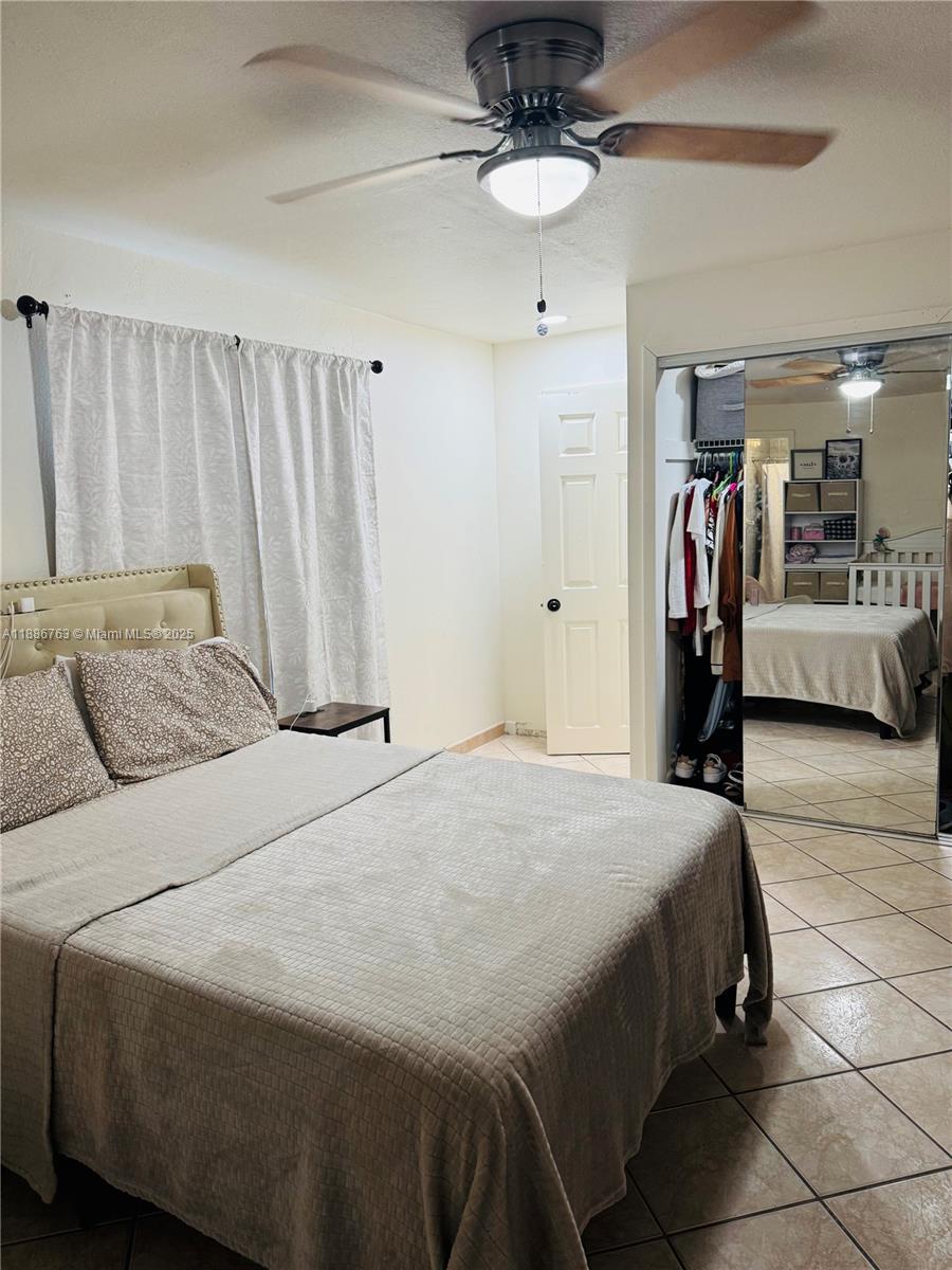 3915 Northwest 4th Terrace Miami, FL 33126 - Photo 38 of 42 a bedroom with a bed and a walk in closet