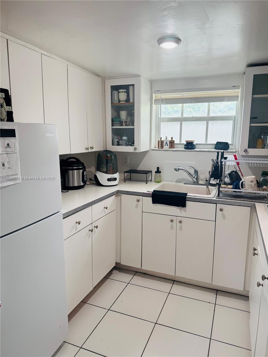 3915 Northwest 4th Terrace Miami, FL 33126 - Photo 40 of 42 a kitchen with white cabinets a sink and appliances