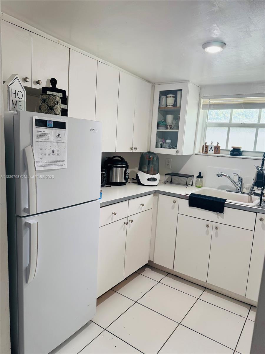 3915 Northwest 4th Terrace Miami, FL 33126 - Photo 41 of 42 a kitchen with appliances a sink and cabinets